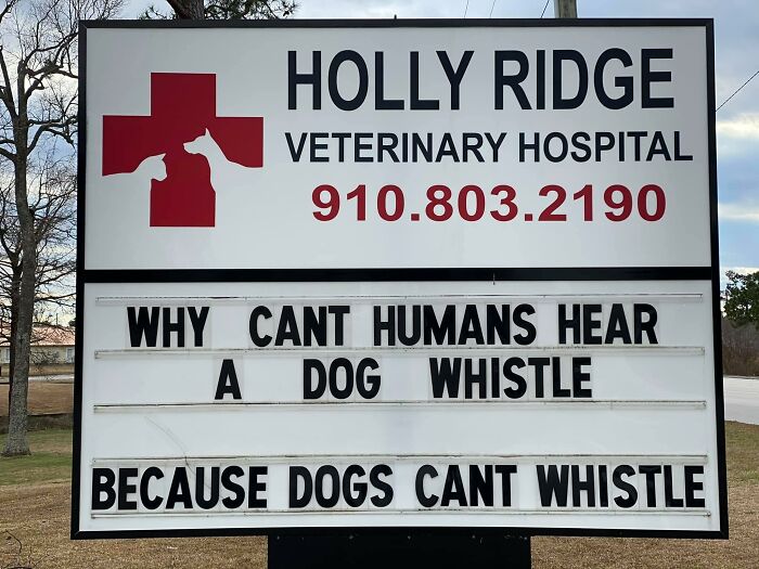 A sign with a red cross and a white sign with black text Description automatically generated